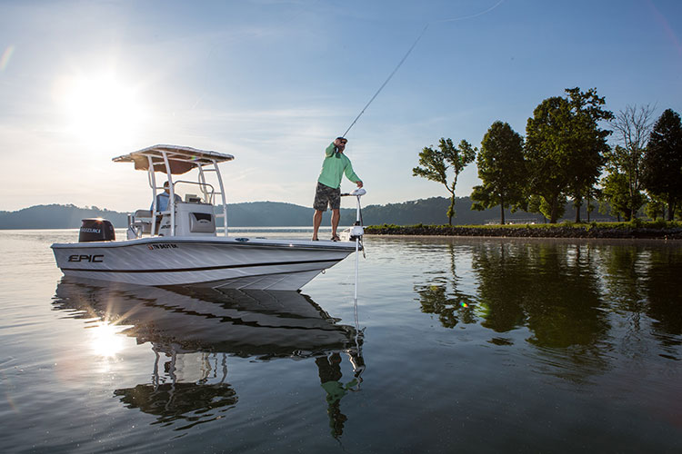 man fly fishing from boat with fishmaster t-top