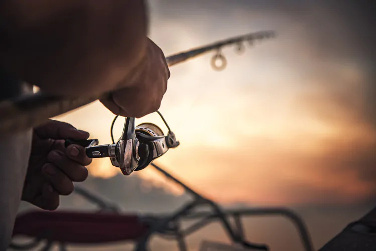 man fishing at sunset