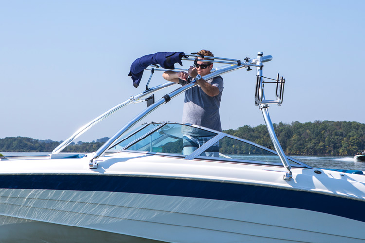 man installing a bimini on a monster wakeboard tower