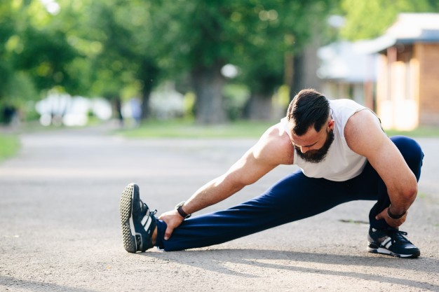 man stretches after exercising